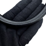 A close-up of Prada Saffiano Leather Galleria curved black textured handle