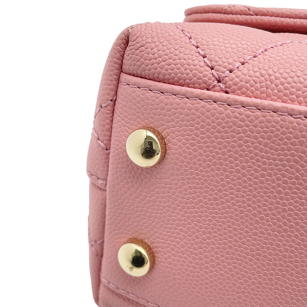 Close-up of CHANEL coco mini  handle bag in caviar leather handbag corner showing gold-tone metal studs and stitching details