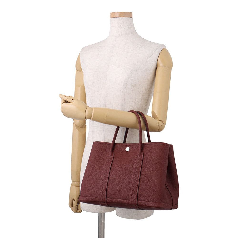 Hermès Garden Party 30 TPM Rouge H Negonda Leather Tote Bag on mannequins arm