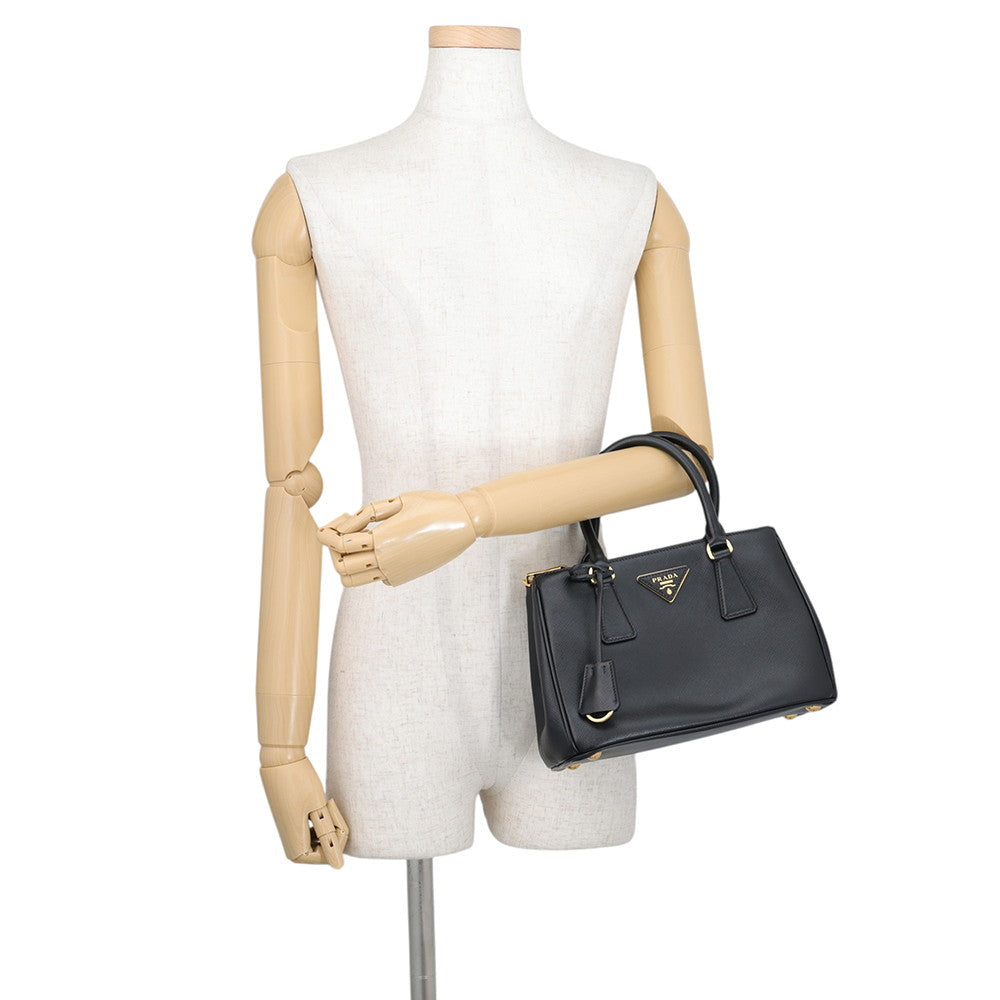 Prada Saffiano Leather Galleria Tote in Black displayed on mannequins arm— Pre-Owned Designer Handbag