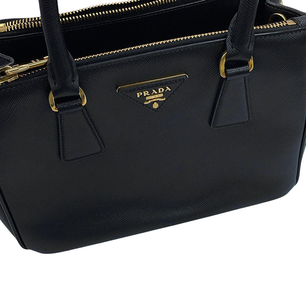 Prada Saffiano Leather Galleria Tote in Black showing the brand front logo on leather surface — Pre-Owned Designer Handbag