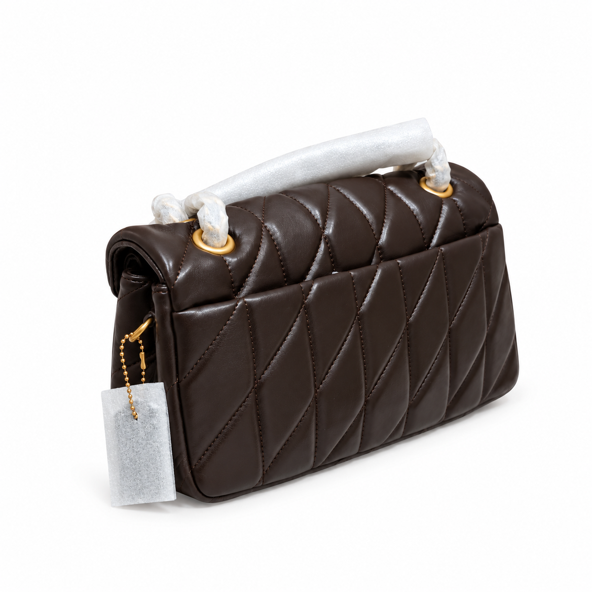 Coach Quilted Tabby 26 maple Brown side profile displaying factory wrapped leather Coach hangtag