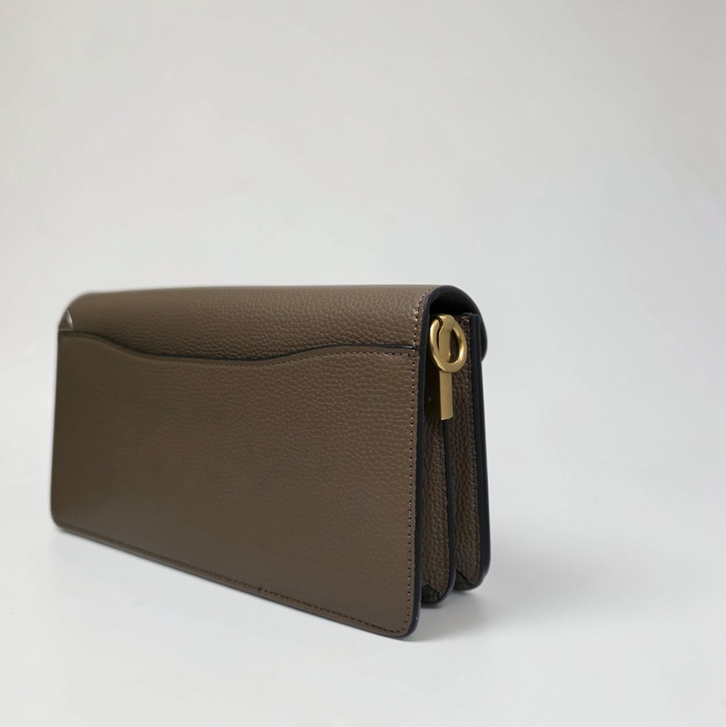 Side profile of COACH Tabby 26 in Dark Stone showing accordion compartments
