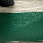 Heat stamped Goyard Paris Made in France logo on green interior calfskin leather pocket.