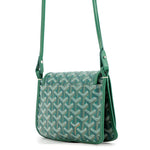 Rear perspective of the green Goyard Plumet bag showing the exterior slip pocket and Goyardine canvas pattern.