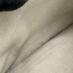 Close-up of the light off-white interior linen lining of the preowned Goyard Plumet bag.