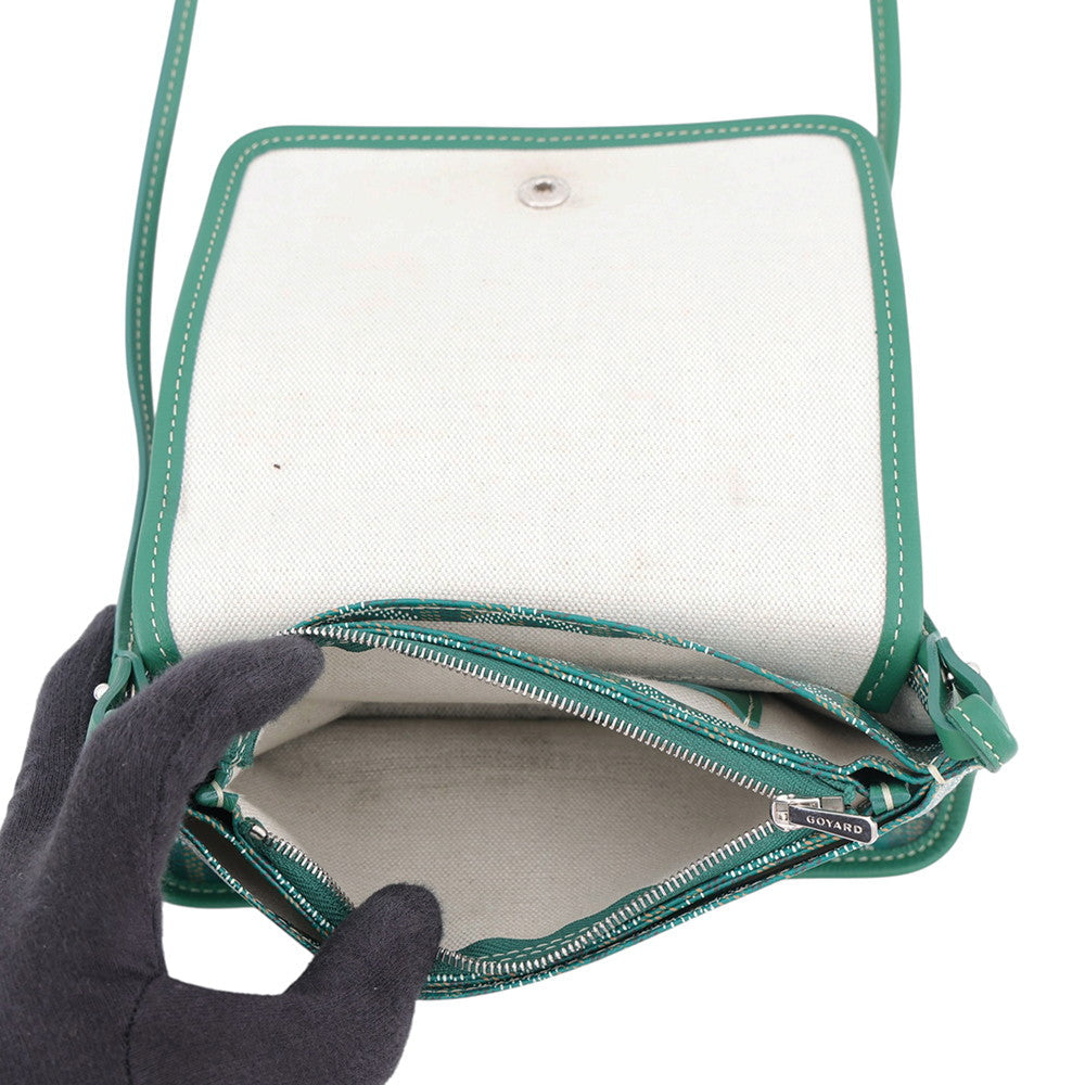 Close-up detail of the silver Goyard zipper pull and interior fabric edge.