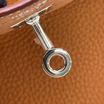 Close-up of palladium touret hardware with protective sticker intact