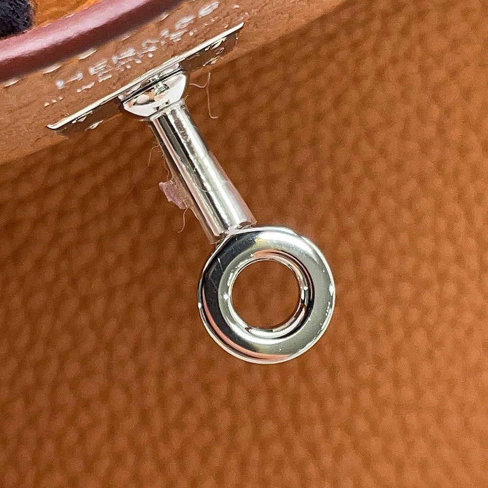Close-up of palladium touret hardware with protective sticker intact