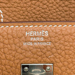 Close-up of Hermès Paris Made in France silver foil stamp on Gold Togo leather