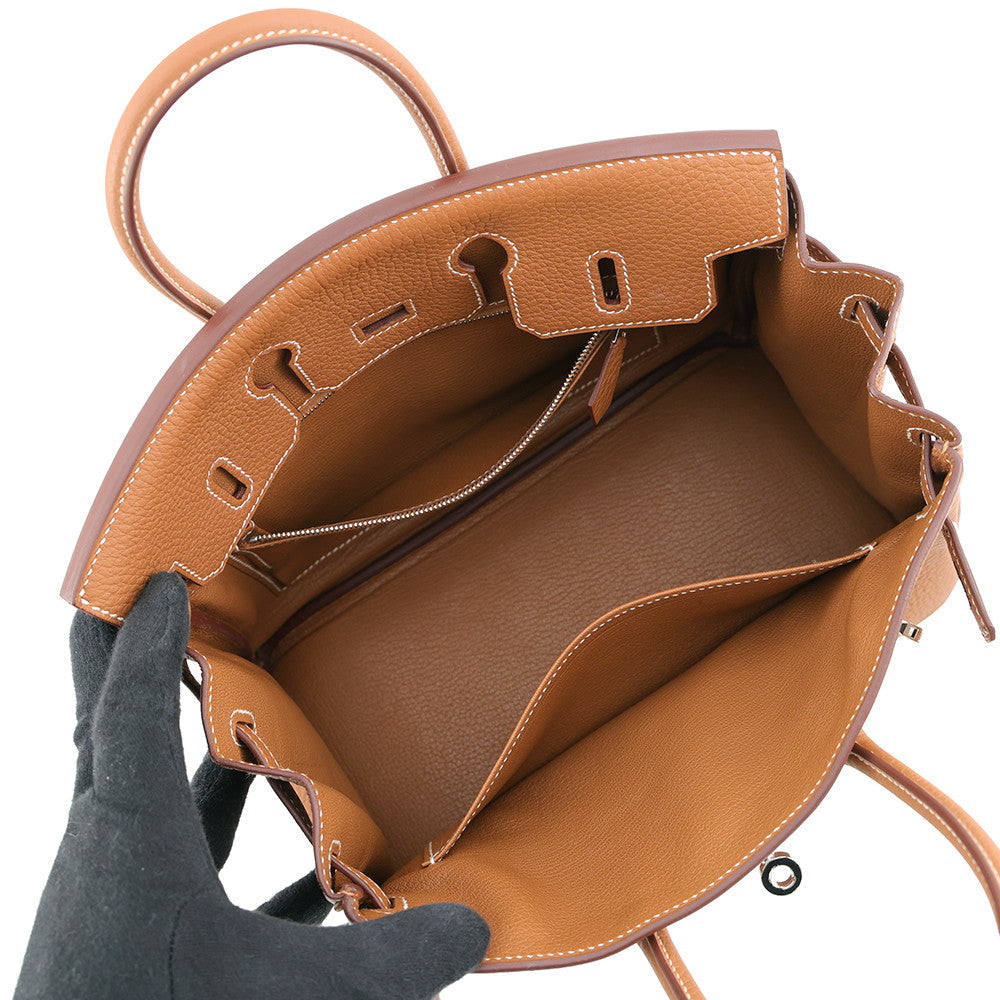 Top-down interior view of Hermès Birkin 25 showing brown leather lining and zip pocket