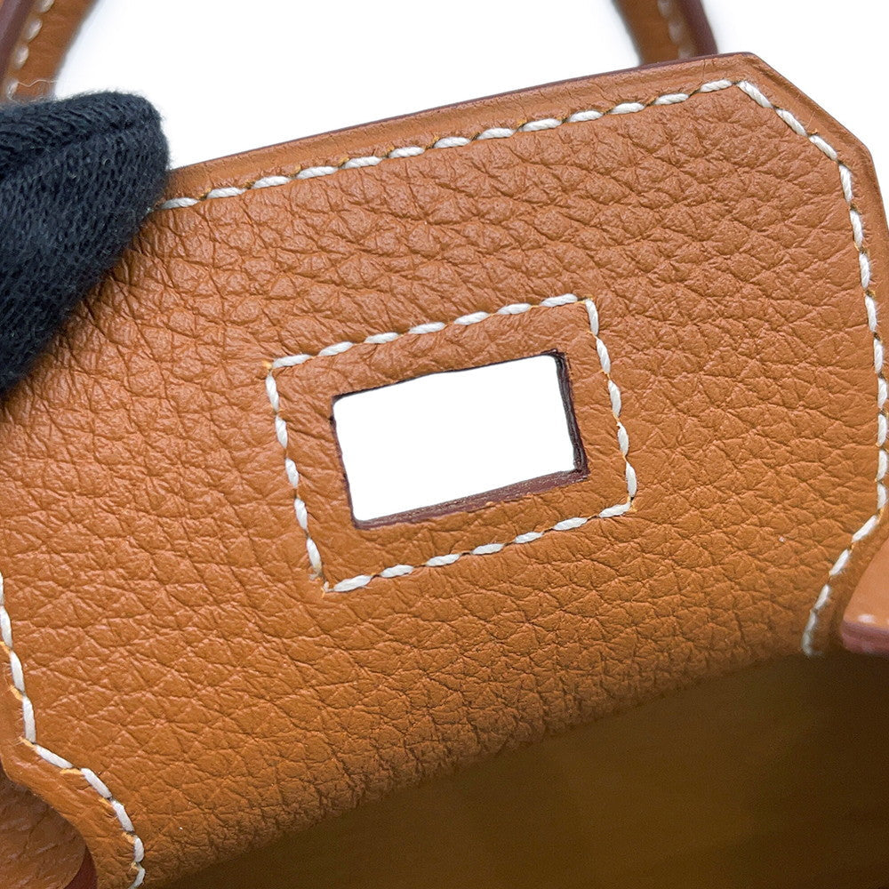 Detailed close-up of white contrast stitching and brown edge resin on Birkin 25