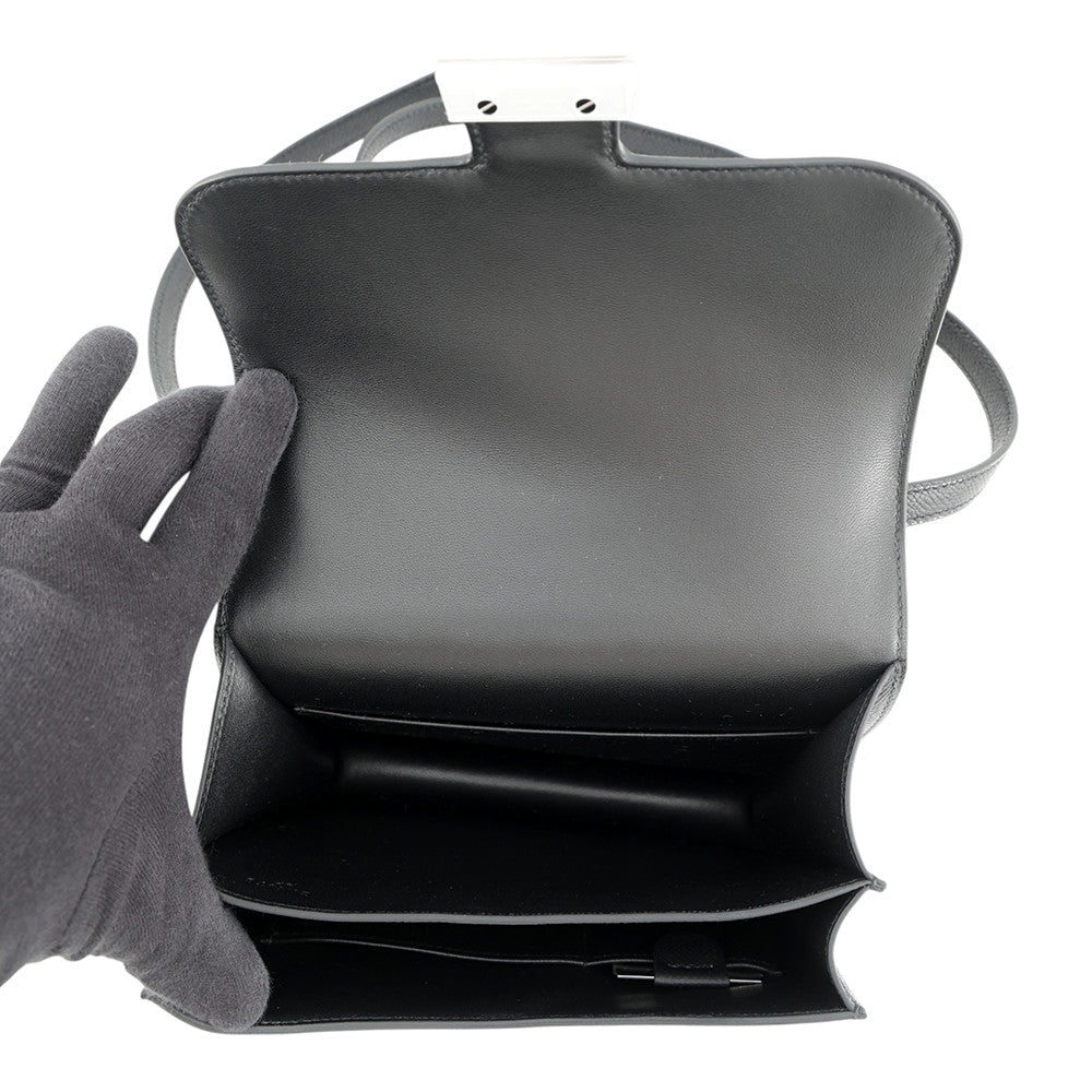 Overhead view of the pristine black lambskin interior compartments of the Hermès Constance 18