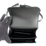 Overhead view of the pristine black lambskin interior compartments of the Hermès Constance 18