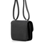 Side profile of the Noir Hermès Constance 18 bag showcasing structured Epsom leather walls.
