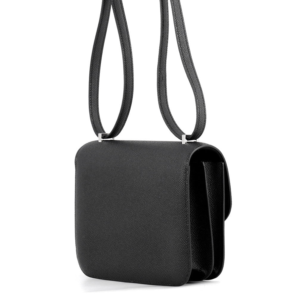 Side profile of the Noir Hermès Constance 18 bag showcasing structured Epsom leather walls.