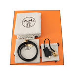 Hermès Kelly 25 complete set including orange box, dustbags, shoulder strap, lock, and keys