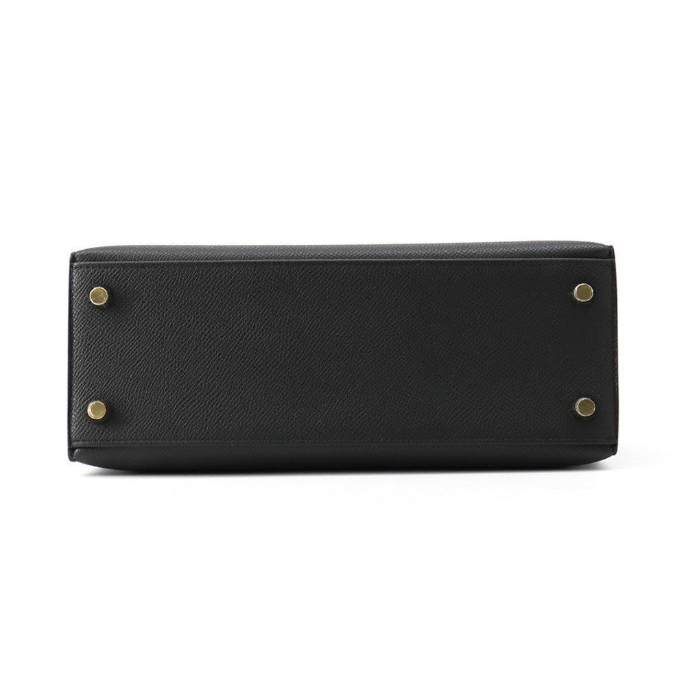 Bottom base of Hermès Kelly Sellier 25 showing Black Epsom leather and protective metal feet