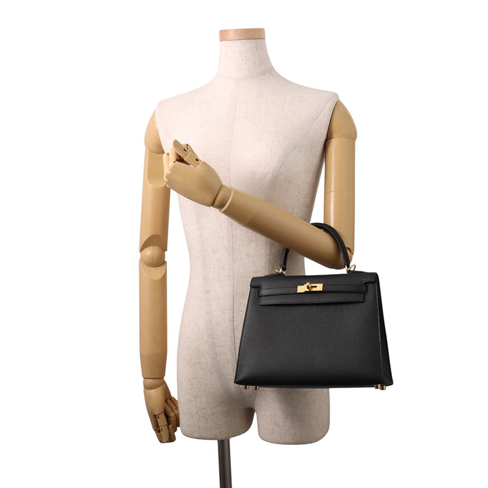 Hermès Kelly Sellier 25 Black Epsom displayed on mannequin for size scale