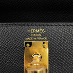 Close-up of Hermès Paris Made in France gold foil stamp and turn-lock hardware