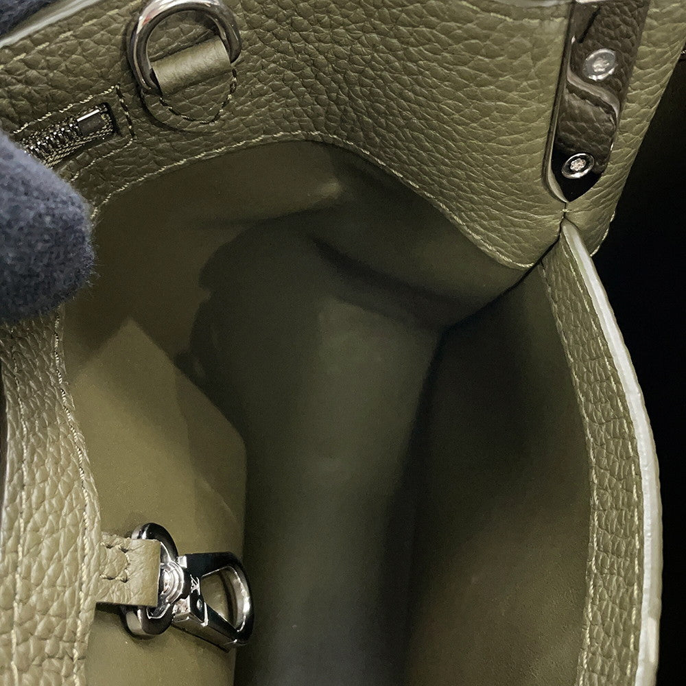 Interior view of Capucines BB showing green leather lining and clasp hook