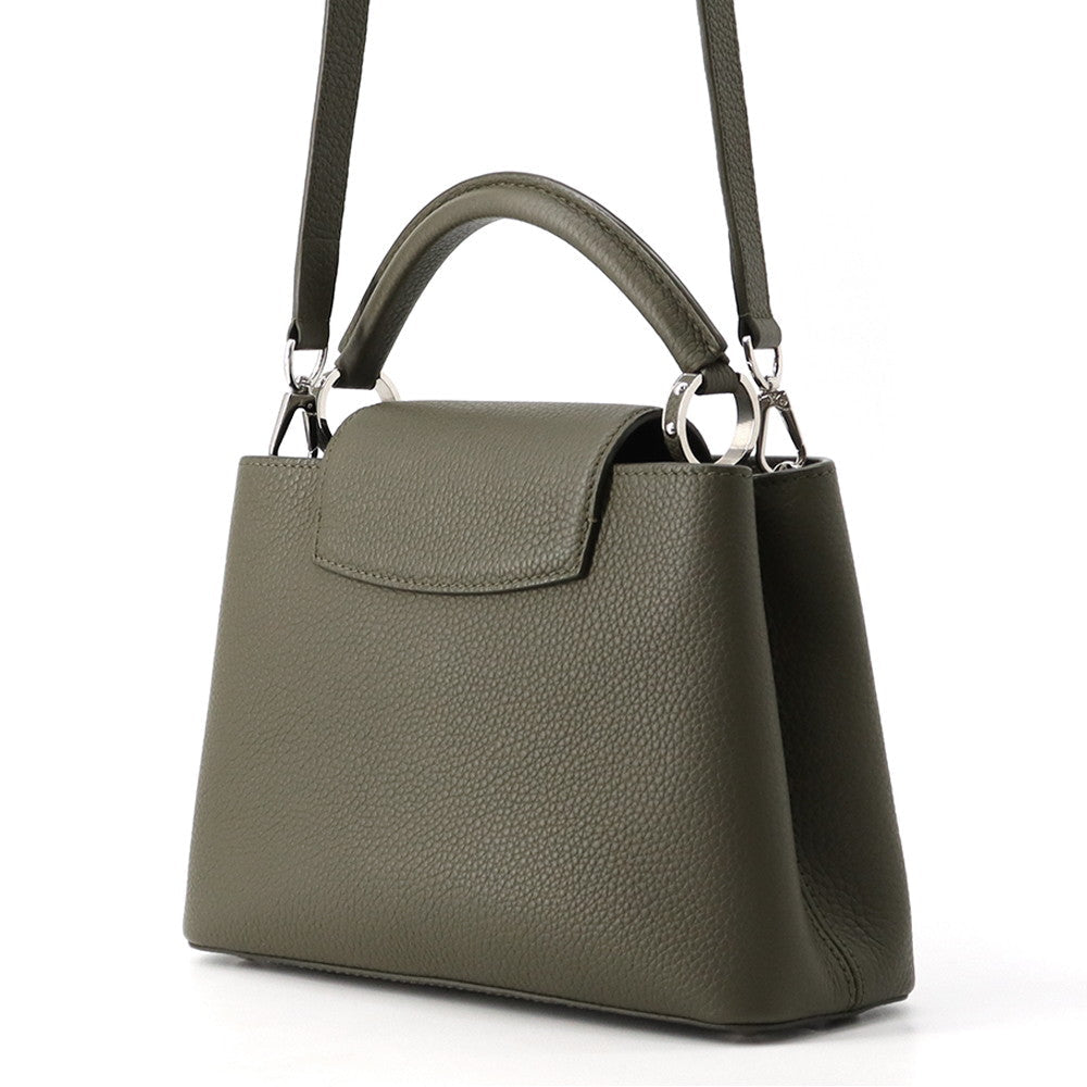 Rear view of Louis Vuitton Capucines BB bag showing flap tucked over top handle