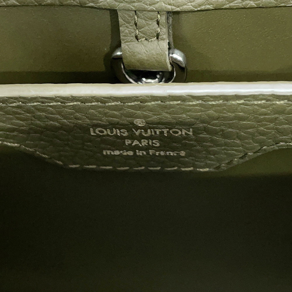 Silver foil heat stamp reading Louis Vuitton Paris Made in France on Khaki leather