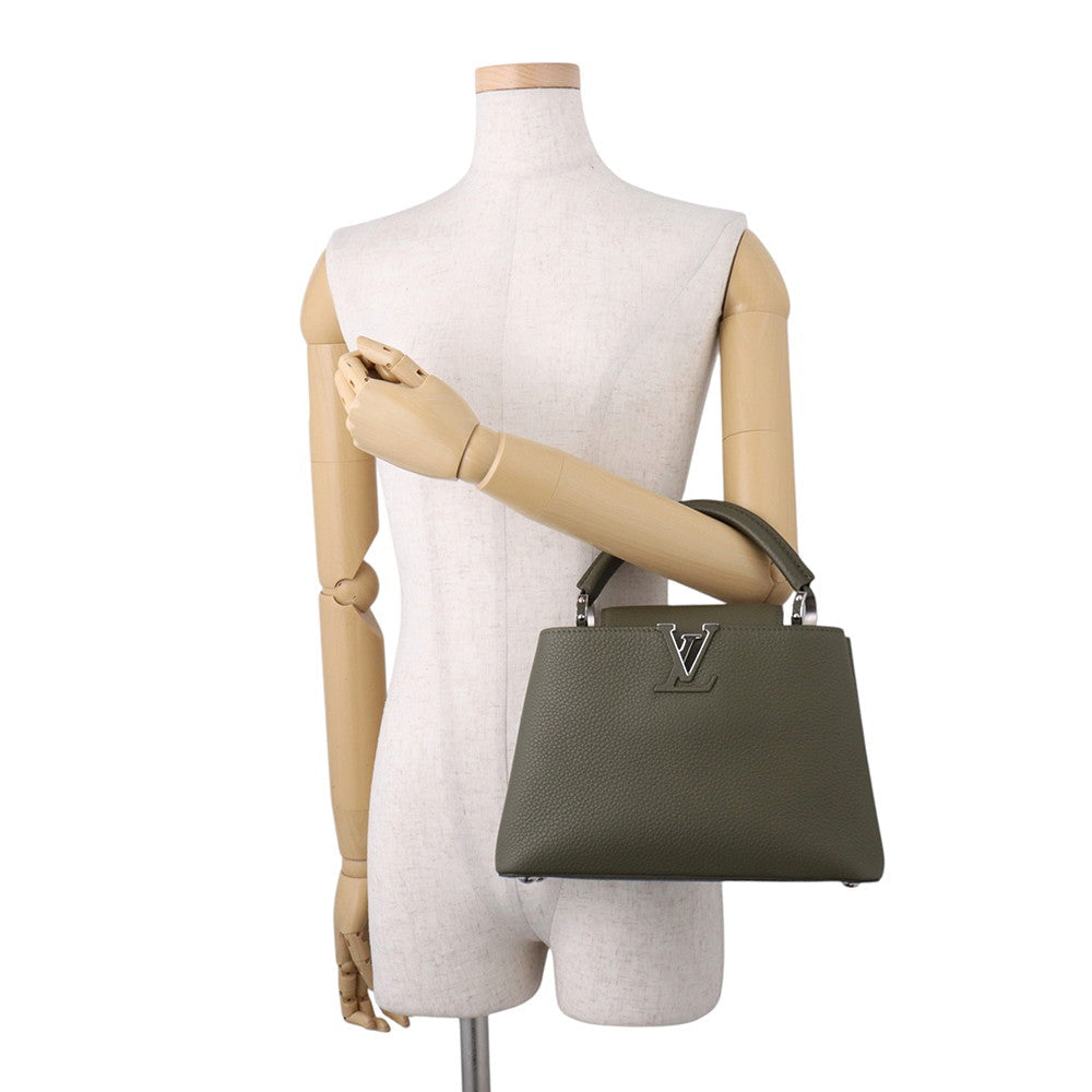 Louis Vuitton Capucines BB held by top handle on mannequin for size reference