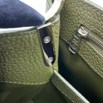 Close-up of silver-tone engraved zip pull and side hardware on Capucines BB