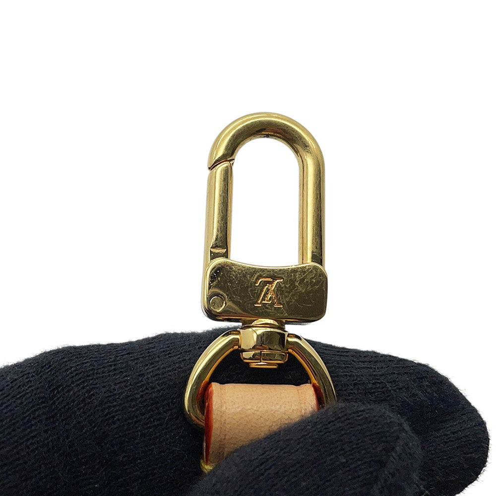 Louis Vuitton gold hardware clip showing minor surface scuffs detail⁠