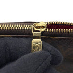 Louis Vuitton gold LV logo zipper pull showing minor surface scuffs detail⁠
