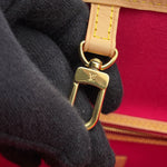 Close-up of gold-tone LV engraved interior clasp hardware on Louis Vuitton Neverfull MM