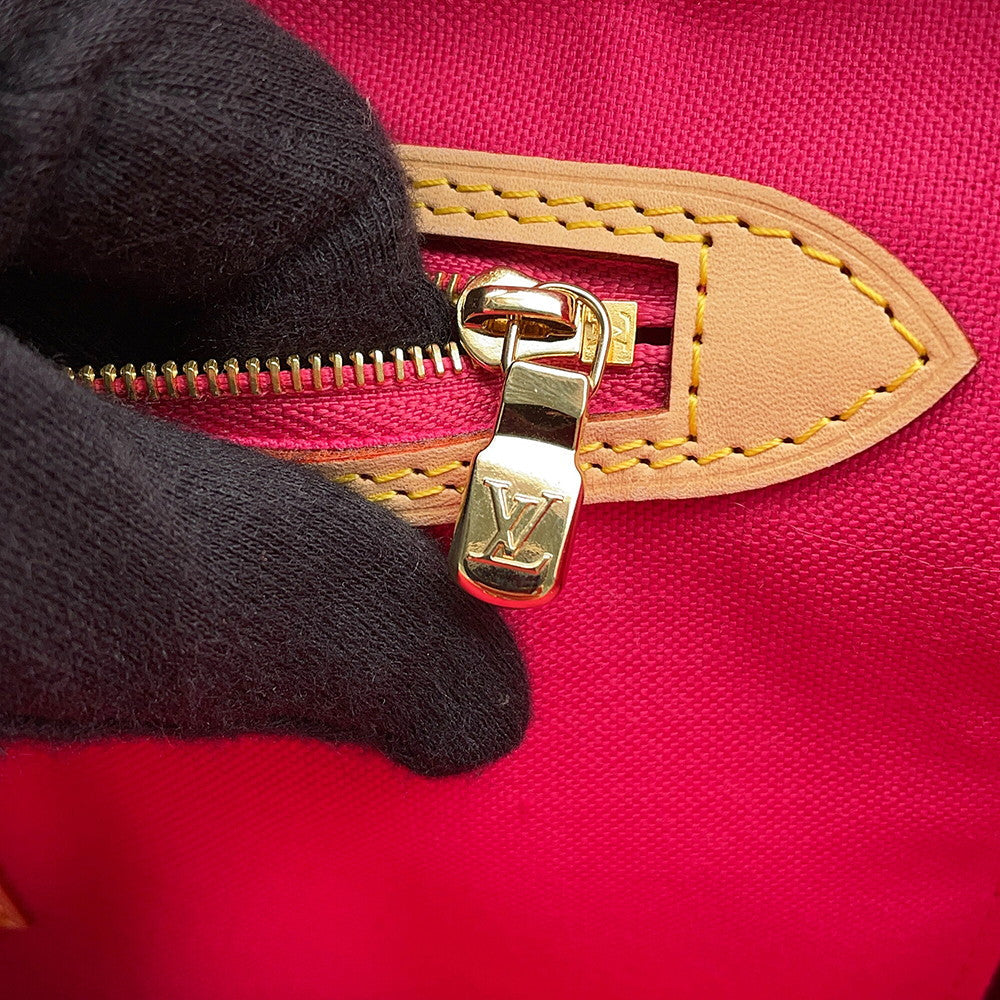 Detailed close-up of gold LV engraved zipper pull on interior pocket of Louis Vuitton Neverfull MM