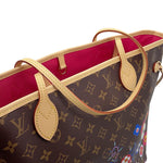 Close-up of pale Vachetta leather shoulder handles and yellow stitching on Louis Vuitton Neverfull MM