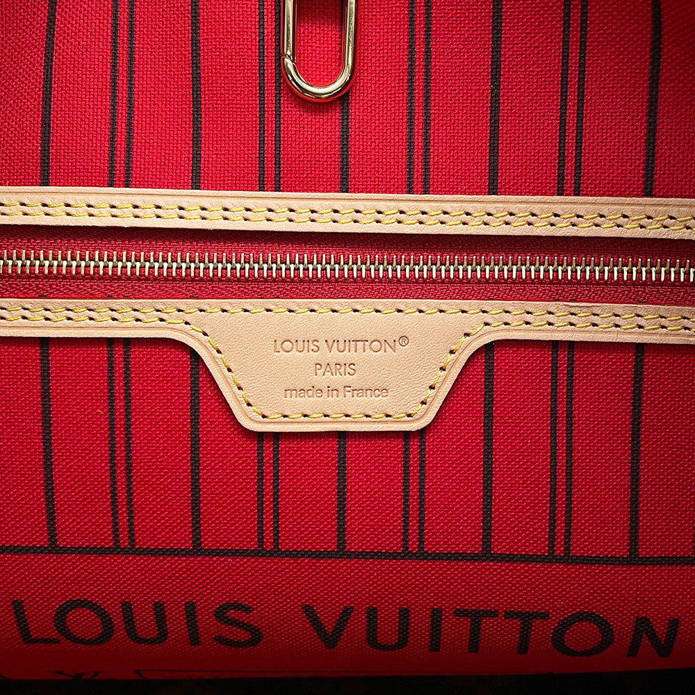 Close-up of interior leather heat stamp reading Louis Vuitton Paris made in France on Neverfull MM