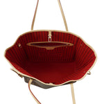 Interior view of Louis Vuitton Neverfull MM showing cherry red striped lining and zip pocket