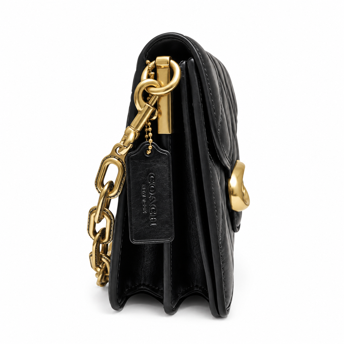 Side profile of the preowned black Coach Chain Tabby quilted bag showing multi-compartment gussets and hangtag.