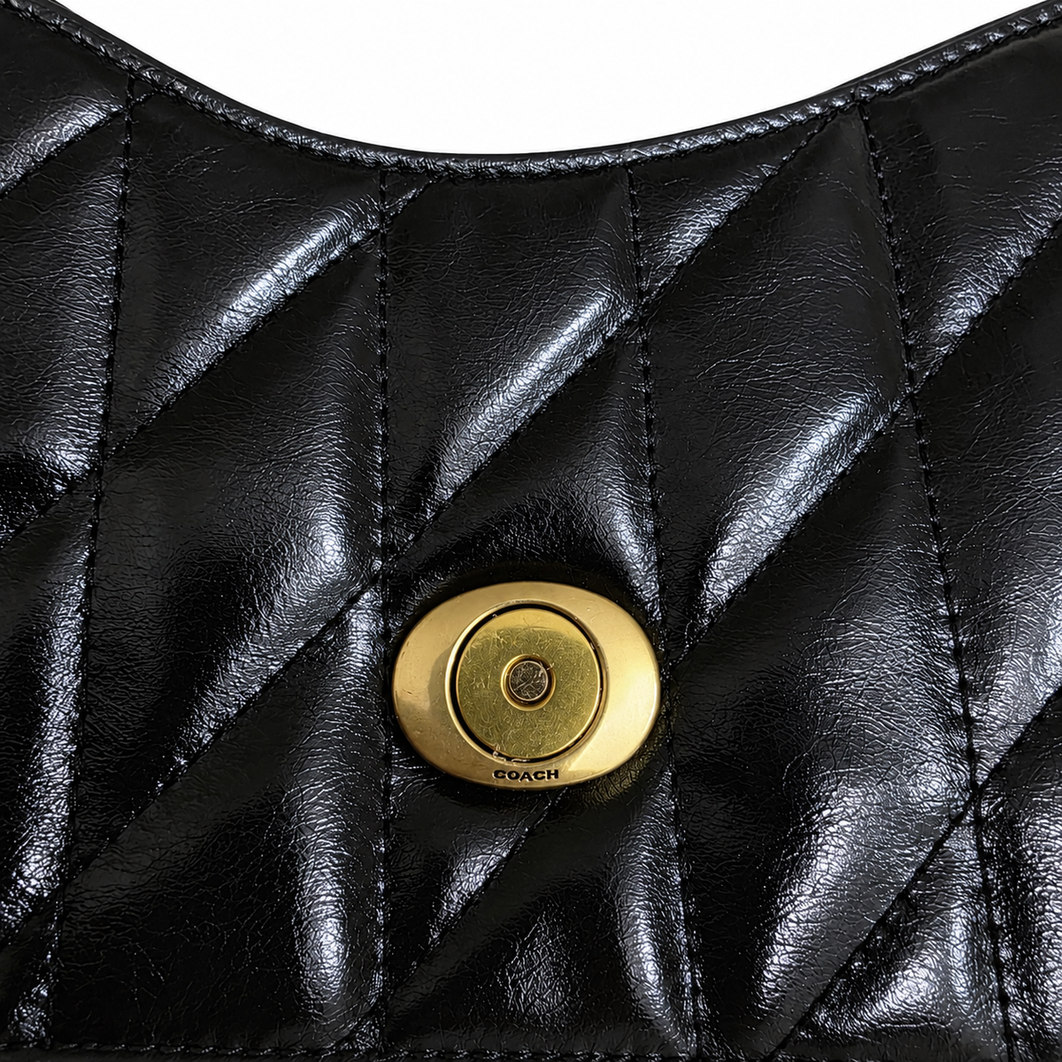 Macro view of black quilted glazed leather and signature brass C push-lock closure on the preowned bag.